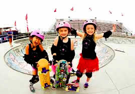 Three 6-year old girls skateborading.