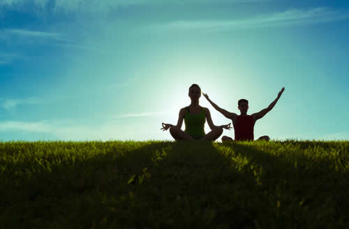 Meditationg in a field at sun rise.