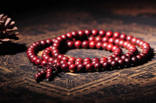 Red Bracelet on Prayer Rug.
