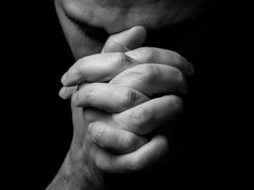 Man with hands praying