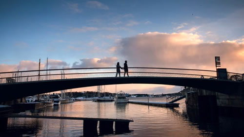 Couple on a bridge hoding hands