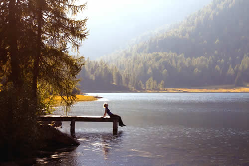 Lone figure by lake.