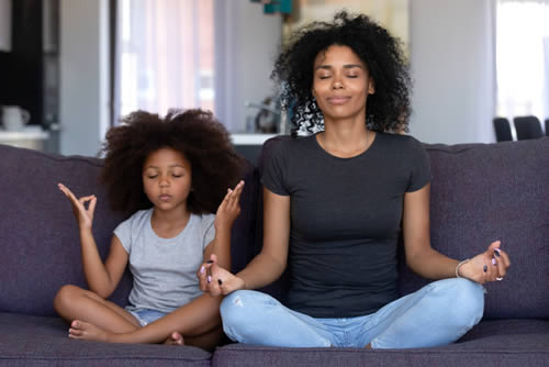 Mother and daughter meditationg
