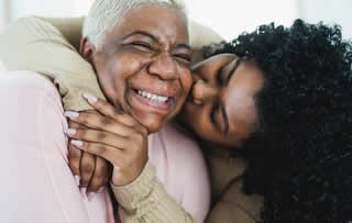 grandmother and granddaughter hugging
